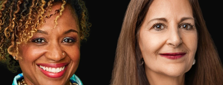 Two women posing in front of a black background