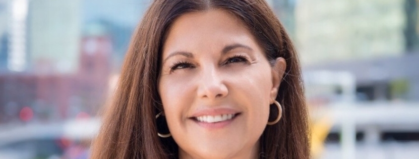 Woman with earings smiling.