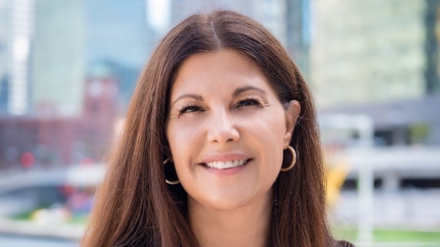 judy_frydland_headshot_crop_2 Woman with earings smiling.